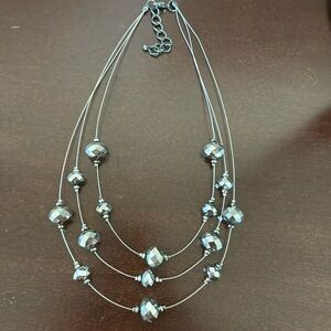 Silver tone beaded three strand necklace